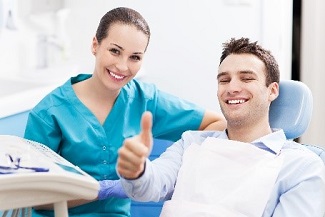 Man giving thumbs up at dentist
